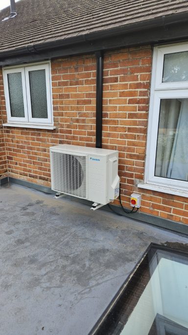 Outdoor air conditioning unit installed neatly beside a brick home